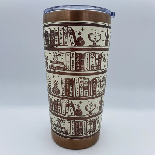 Close-up of bookshelf laser engraving on stainless steel tumbler