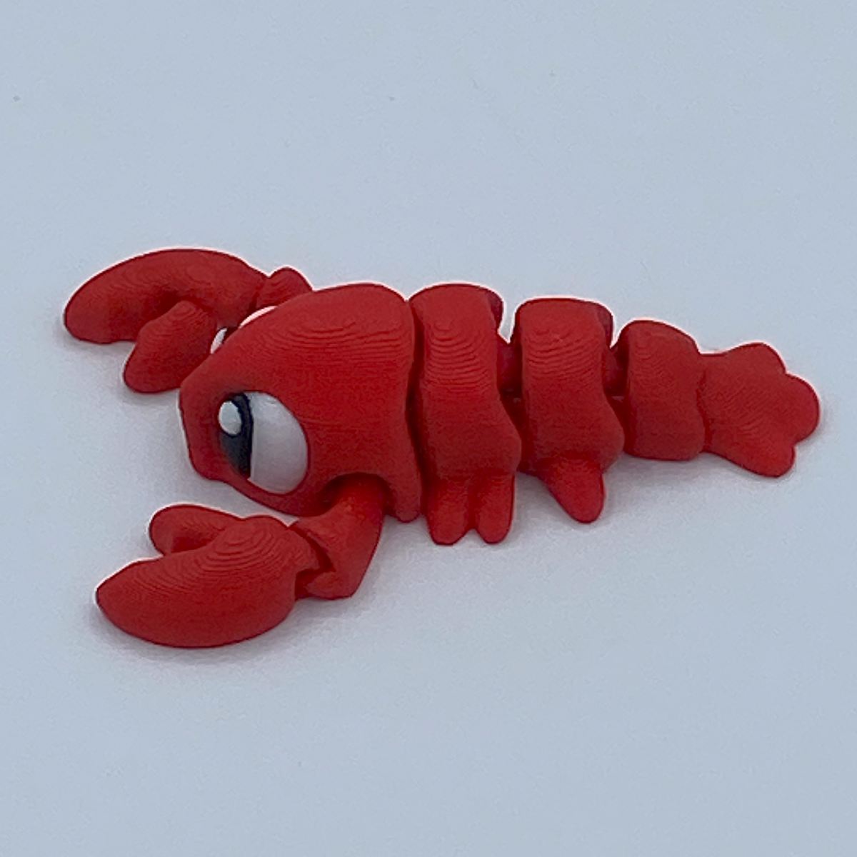 Red lobster toy figure on a white background