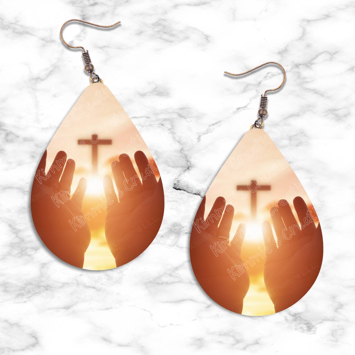 Hand Outreaching to Cross Teardrop Earrings