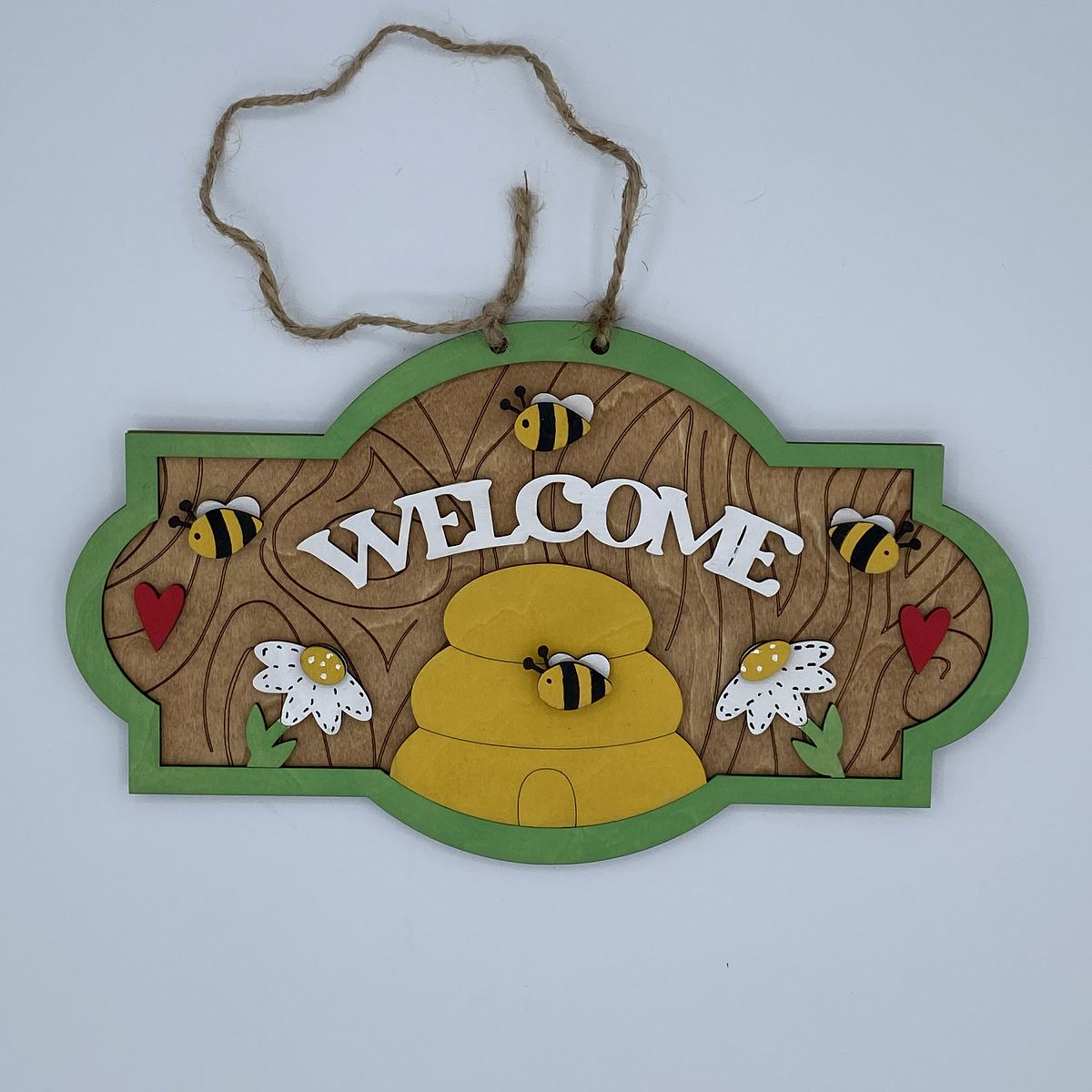 Wooden 'Welcome' sign with bees, flowers, and a beehive