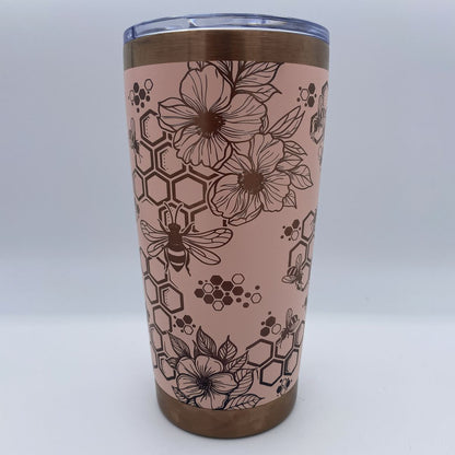Close-up of bees, honeycomb, and flowers laser engraved on tumbler