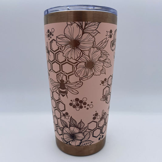 Close-up of bees, honeycomb, and flowers laser engraved on tumbler