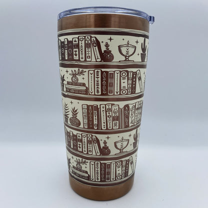 Close-up of bookshelf laser engraving on stainless steel tumbler
