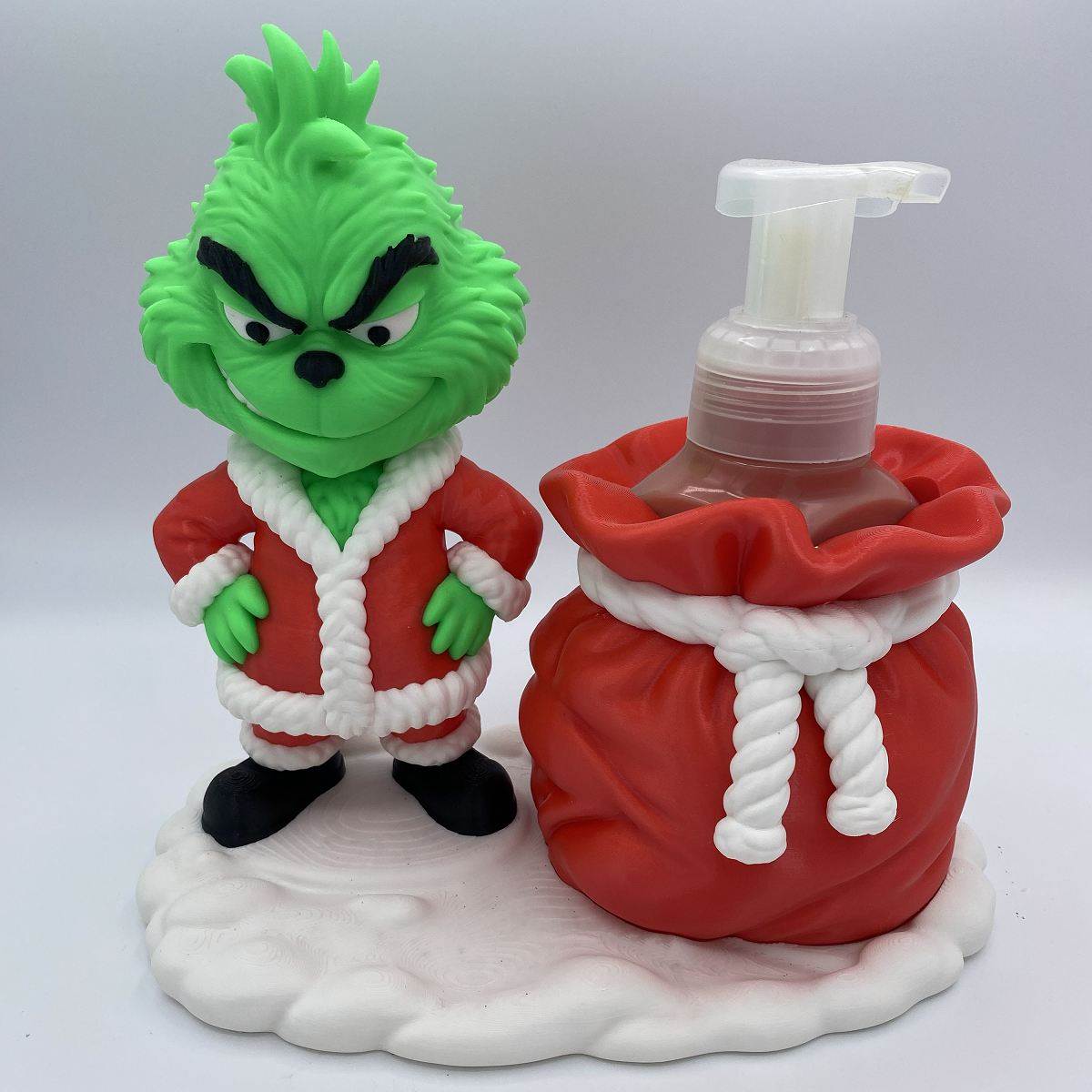 Close-up of Grinch soap holder holding a Bath and Body Works bottle