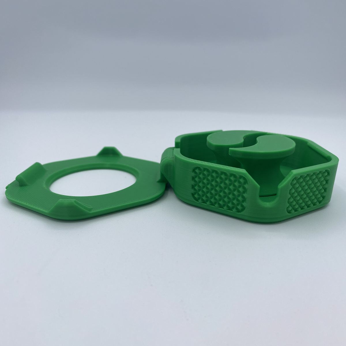 Green plastic component on a white background
