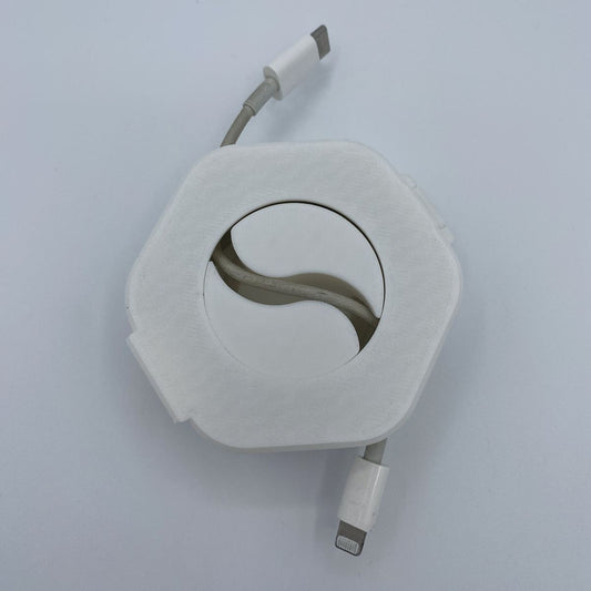 Retractable cable with white casing on a light gray background