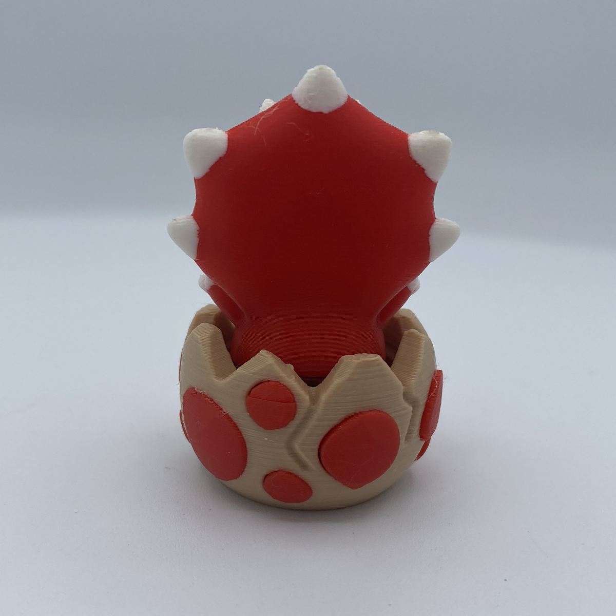 Baby dino clicker fidget shown from another angle