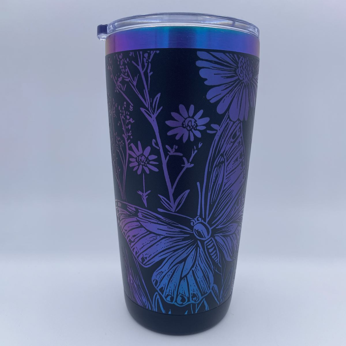 Wildflowers and Butterflies engraved tumbler in blue and purple rainbow finish with laser engraved floral design