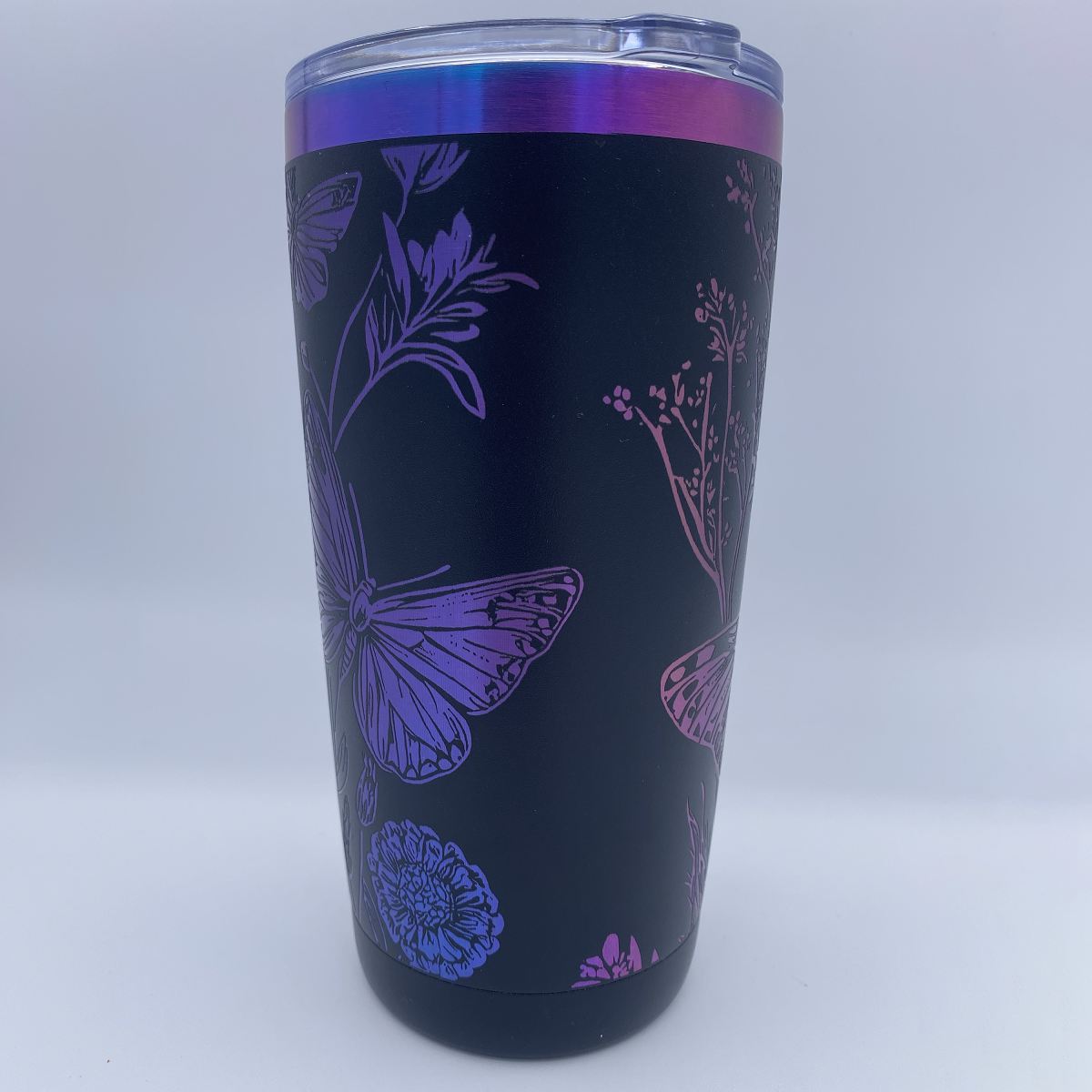 Wildflowers and Butterflies engraved tumbler in blue and purple rainbow finish with laser engraved floral design
