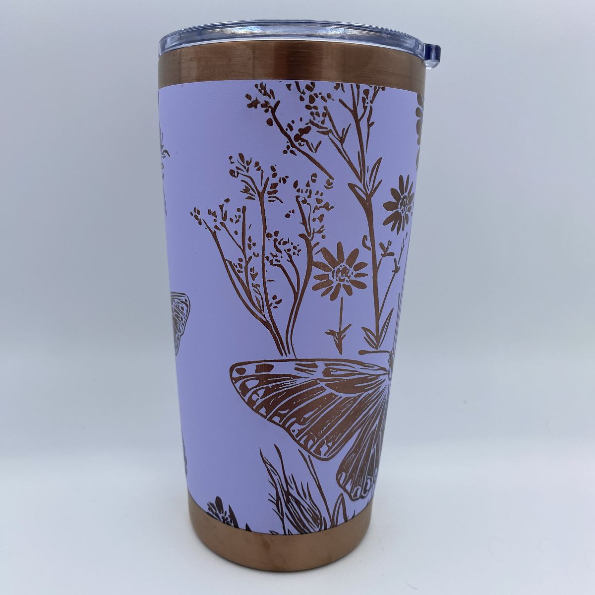  Close-up of wildflowers and butterflies laser engraving on tumbler 
